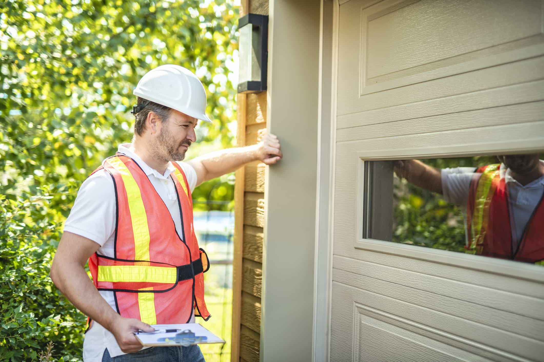Man Inspecting Garage Door